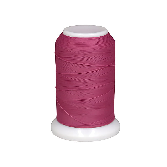 Spool of dark pink woolly nylon thread.