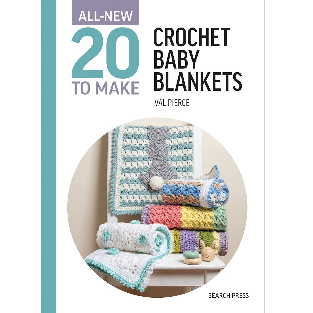 Rolled up baby blankets in pastel colours displayed on a chair.