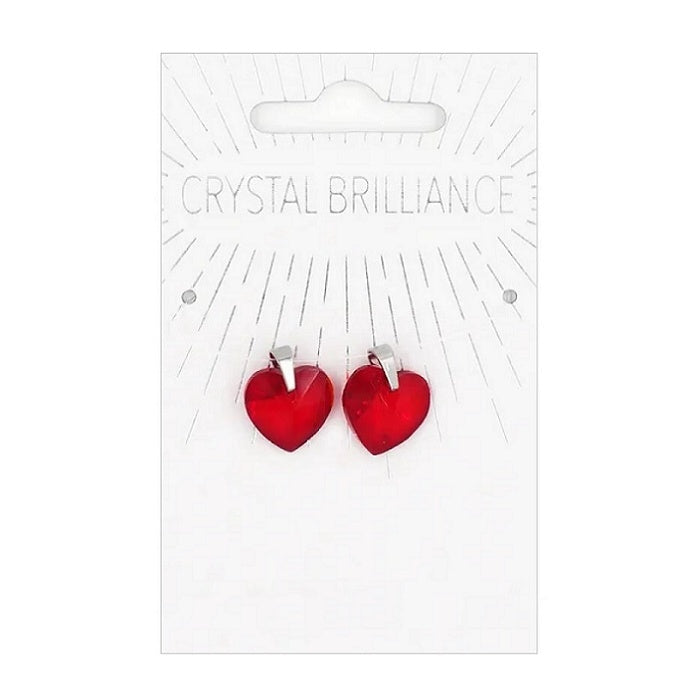 Two red heart shaped pendants on a card.