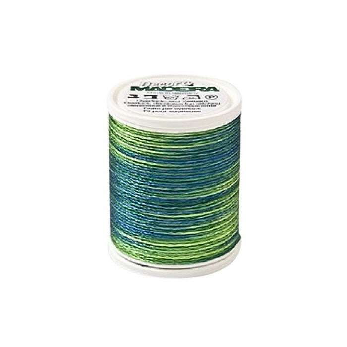 Spool of green variagated thread with Madeira branding.