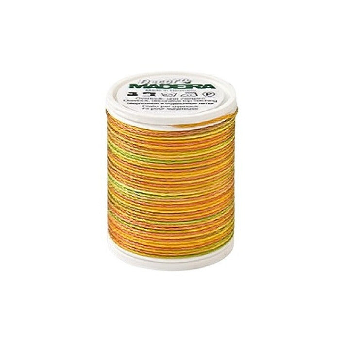 Spool of orange variagated thread with Madeira branding.