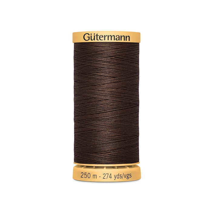 Spool of brown cotton thread with Gutermann branding.