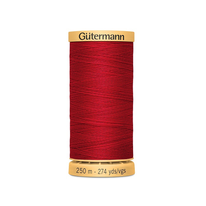 Spool of red cotton thread with Gutermann branding.