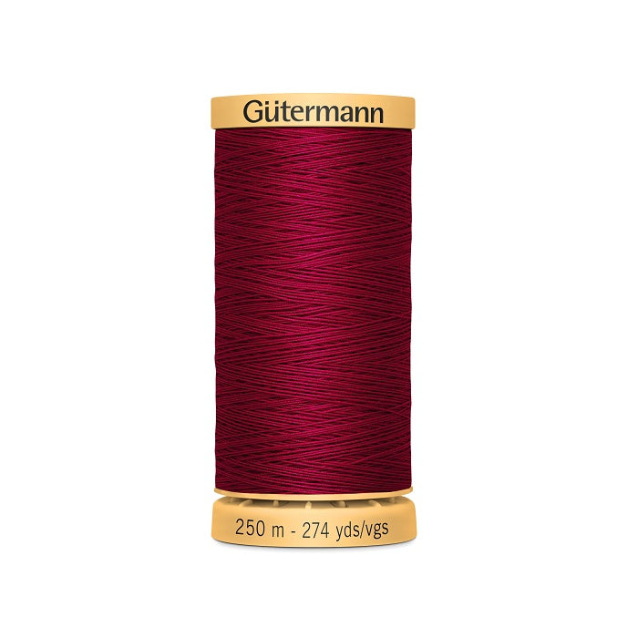 Spool of dark red cotton thread with Gutermann branding.