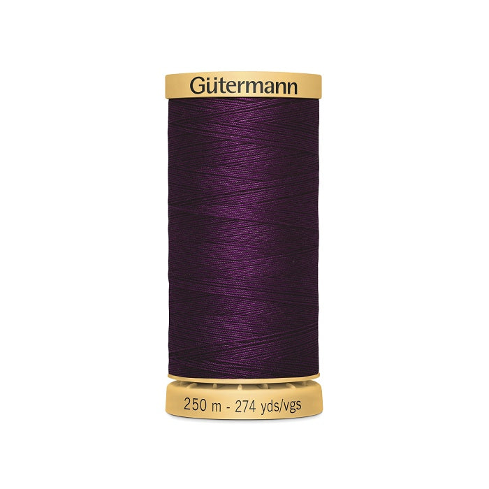 Spool of dark purple cotton thread with Gutermann branding.