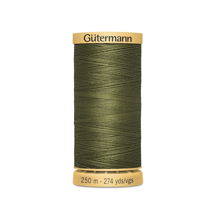 Spool of green cotton thread with Gutermann branding.