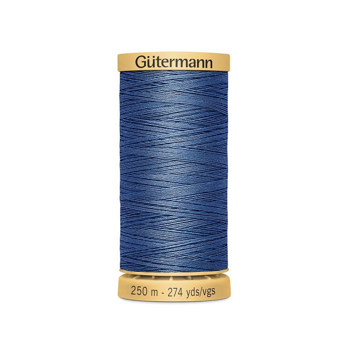 Spool of blue cotton thread with Gutermann branding.