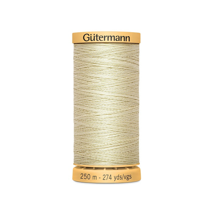 Spool of beige cotton thread with Gutermann branding.