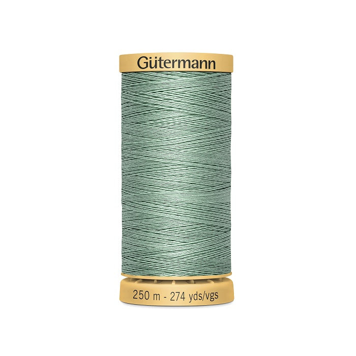 Spool of light green cotton thread with Gutermann branding.