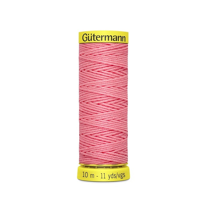 Pink elastic sewing thread spool with gutermann branding.