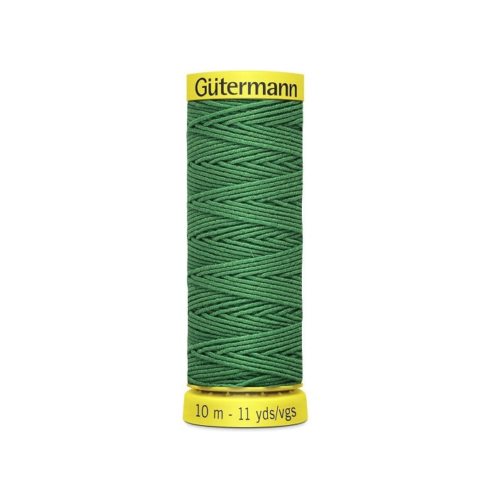 Emerald green elastic sewing thread spool with gutermann branding.