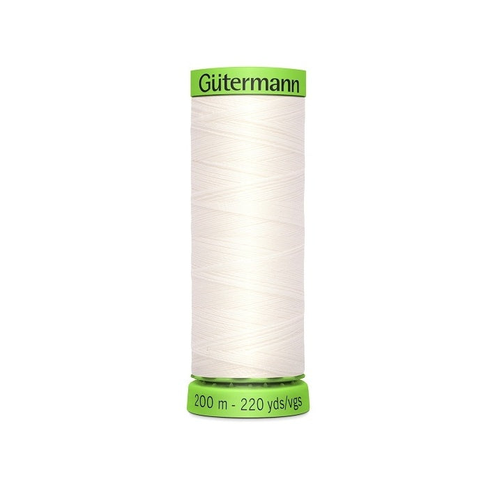 Spool of off white extra fine thread with Gutermann branding.