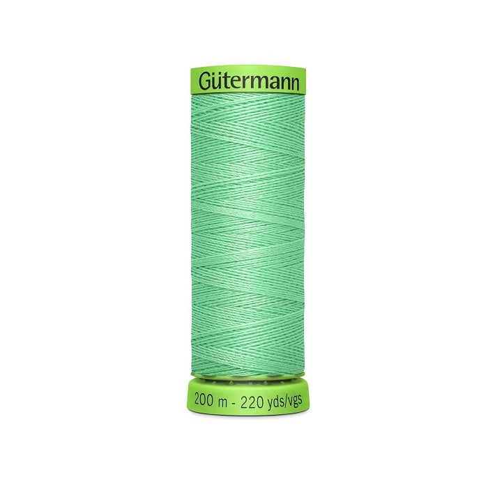 Spool of light green extra fine thread with Gutermann branding.