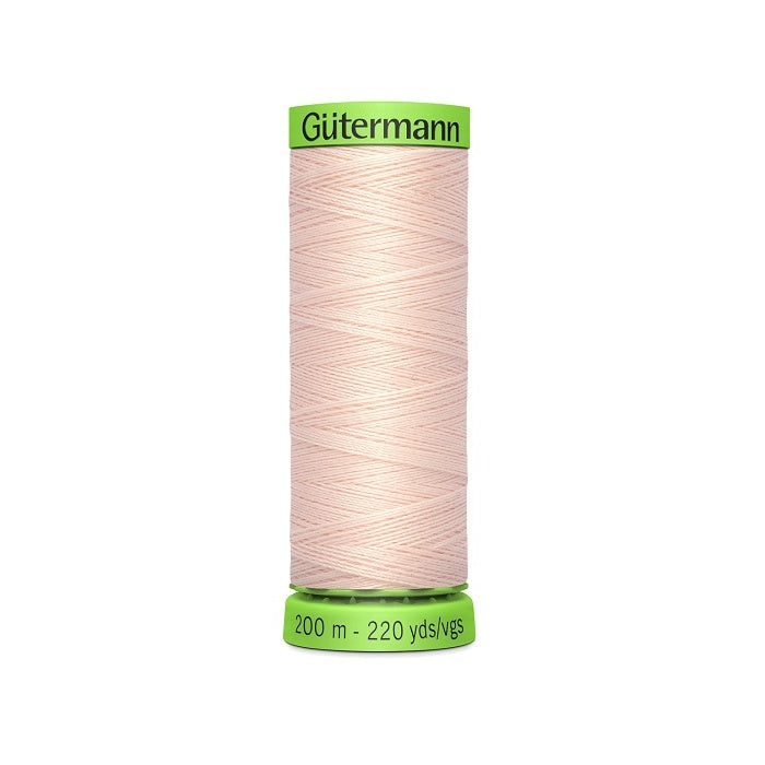 Spool of pale pink extra fine thread with Gutermann branding.
