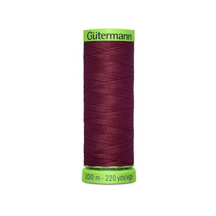 Spool of dark red extra fine thread with Gutermann branding.