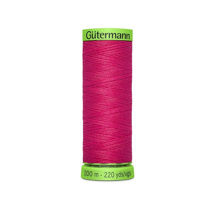 Spool of dark pink extra fine thread with Gutermann branding.