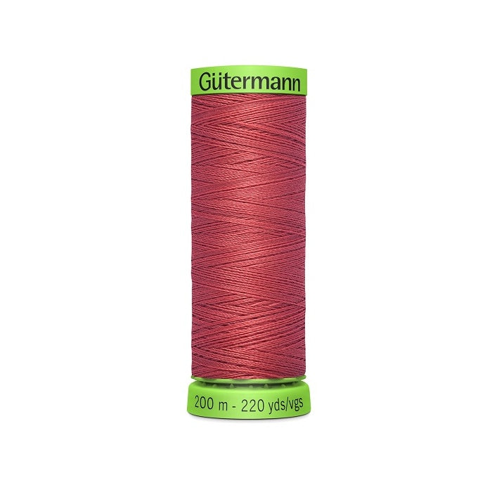 Spool of red extra fine thread with Gutermann branding.