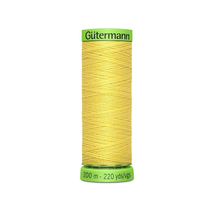 Spool of yellow extra fine thread with Gutermann branding.