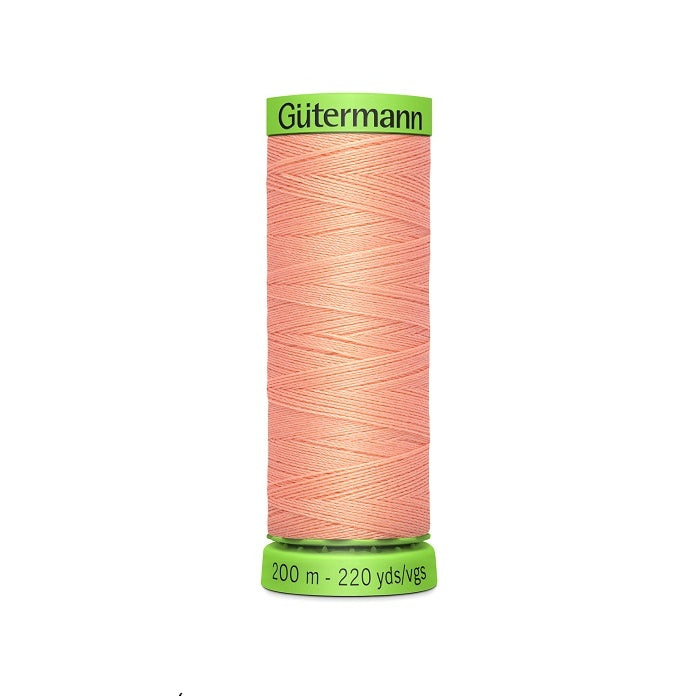 Spool of peach pink extra fine thread with Gutermann branding.