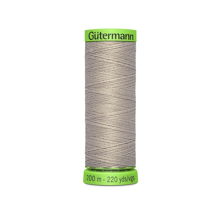 Spool of beige extra fine thread with Gutermann branding.