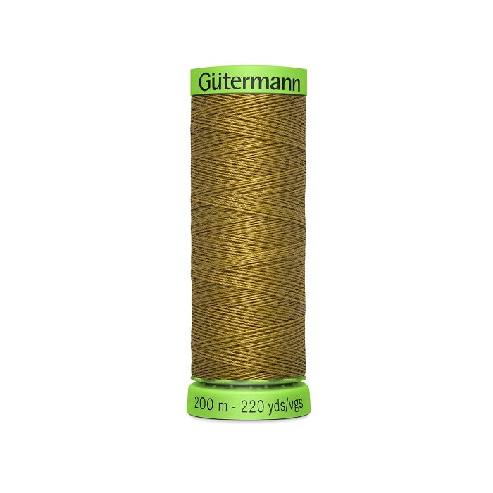 Spool of khaki brown extra fine thread with Gutermann branding.