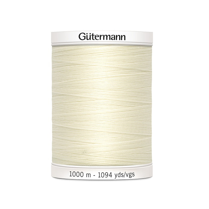 Ivory sewing thread spool with Gutermann branding.
