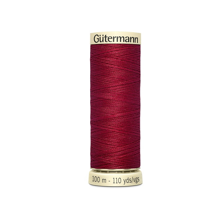 Spool of red thread with Gutermann branding.
