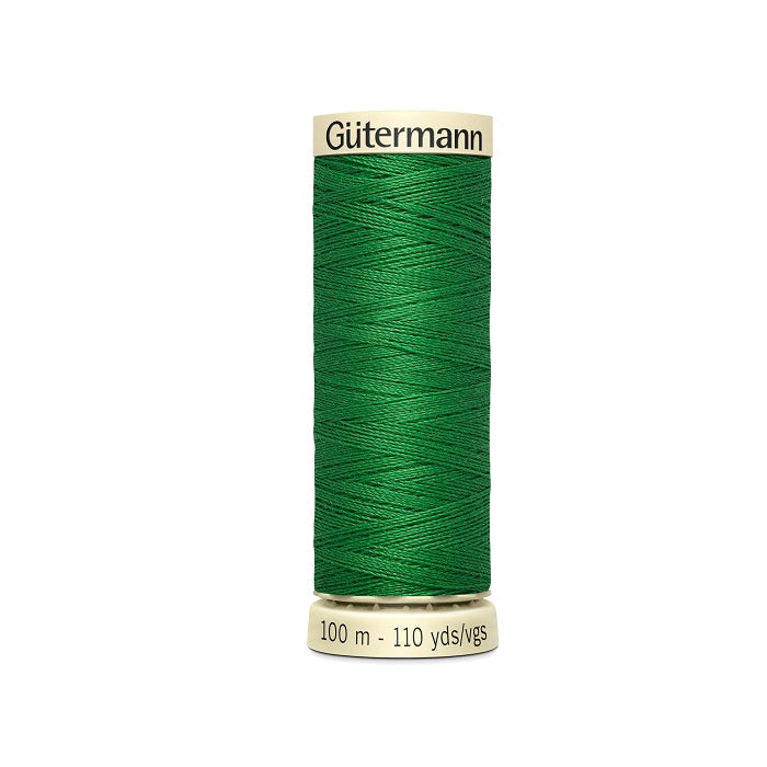Spool of green thread with Gutermann branding.