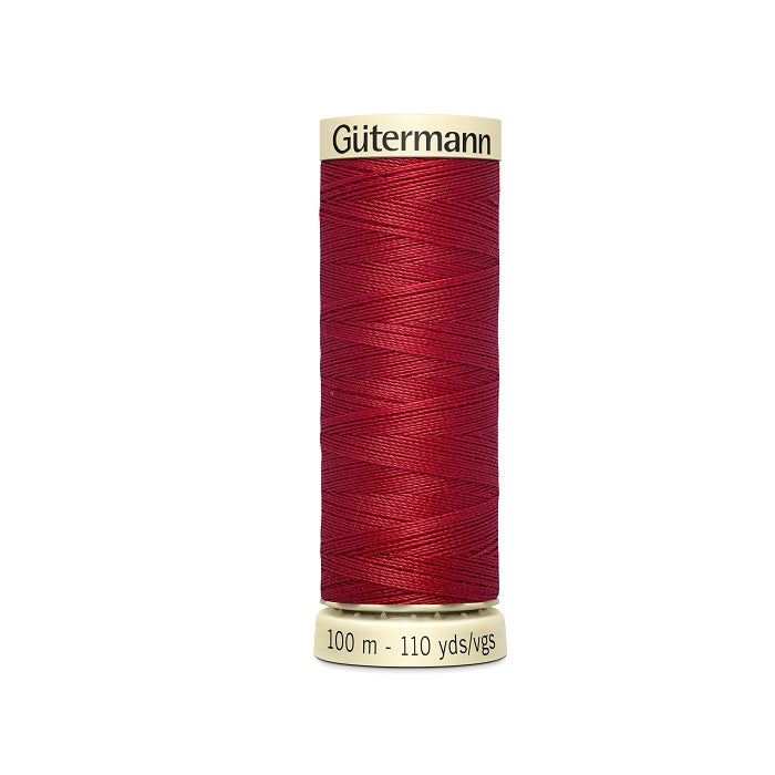 Spool of red thread with Gutermann branding.