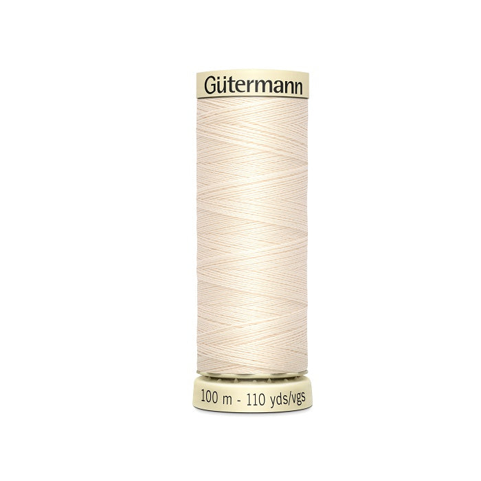 Spool of light beige thread with Gutermann branding.