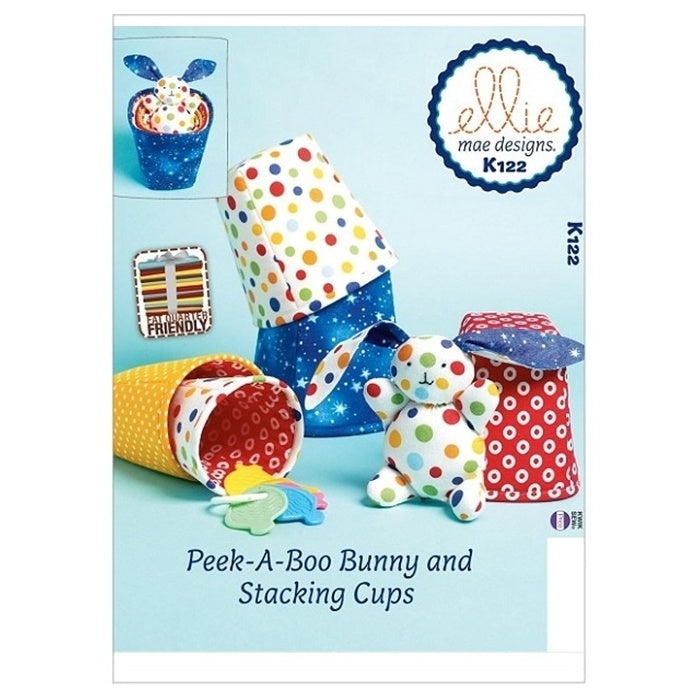 Sewing pattern cover with toy bunny and fabric stacking cups.