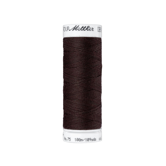 Spool of dark brown thread with Mettler branding.
