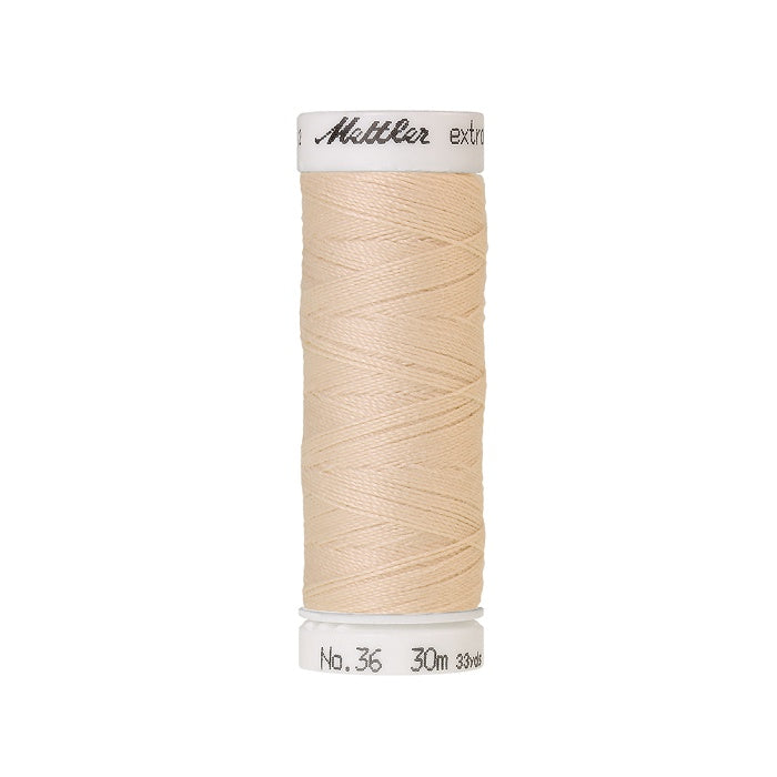 Spool of beige extra strong thread with Mettler branding.