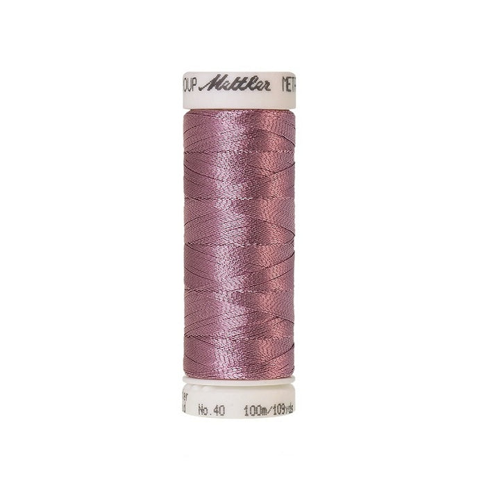 Spool of pink metallic thread with Mettler branding.