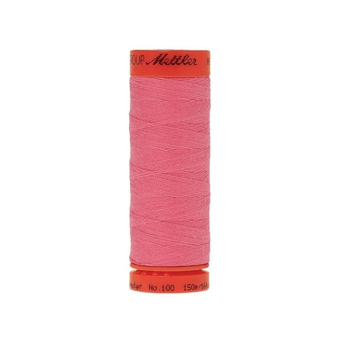 Spool of Mettler 150m pink thread.