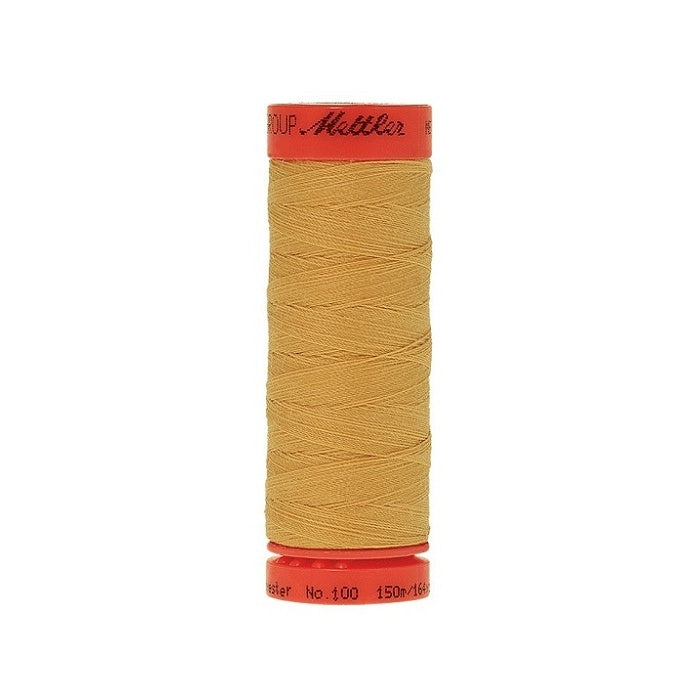 Spool of Mettler 150m mustard thread.