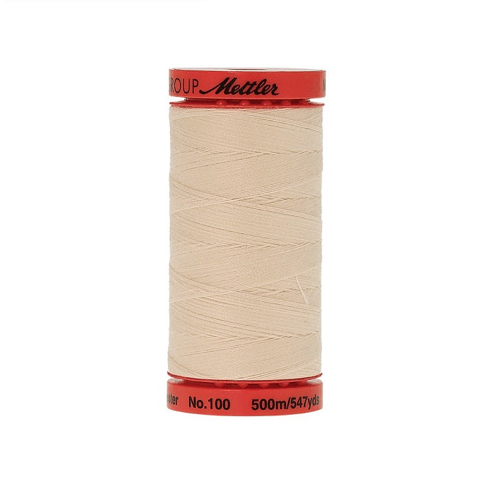 Spool of Mettler 500m light beige thread.
