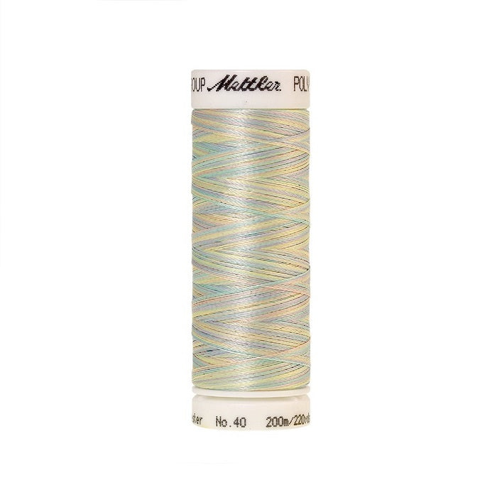 Spool of Mettler light pink green and yellow variegated thread.