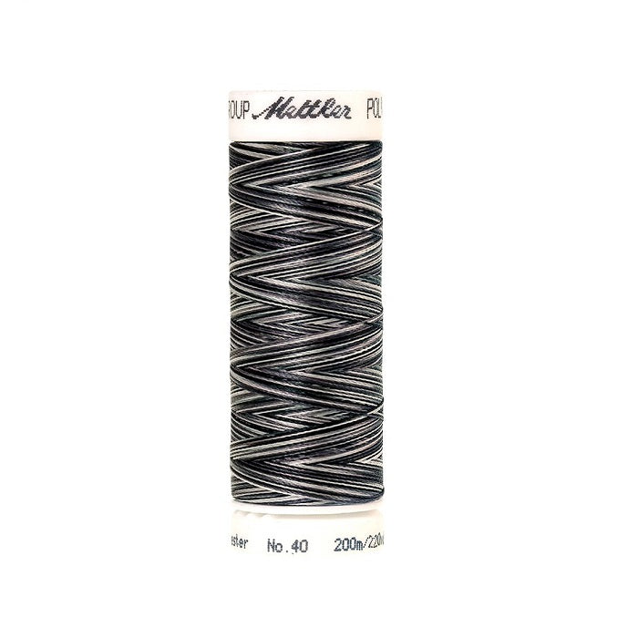 Spool of Mettler black and white variegated thread.