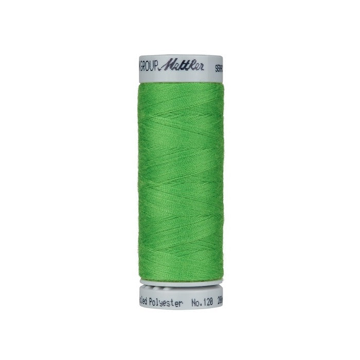 Spool of green thread with Mettler Seracycle branding.