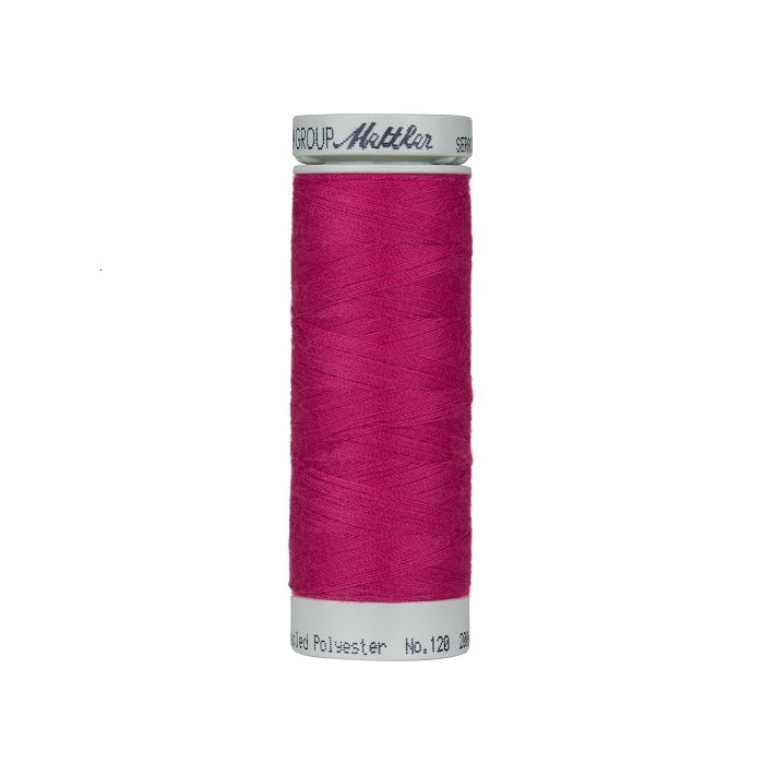 Spool of dark pink thread with Mettler Seracycle branding.