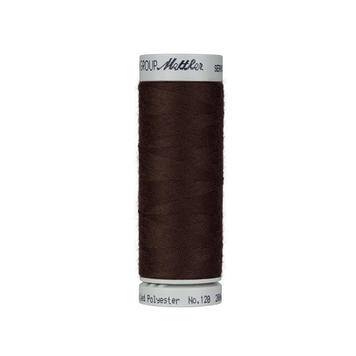Spool of dark brown thread with Mettler Seracycle branding.