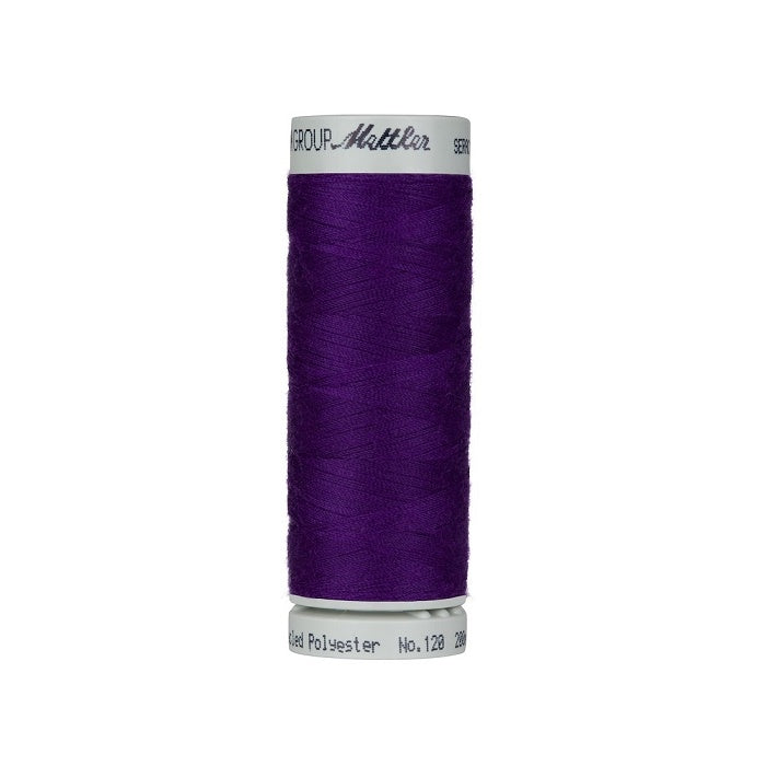 Spool of dark purple thread with Mettler Seracycle branding.