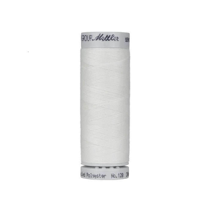 Spool of natural thread with Mettler Seracycle branding.