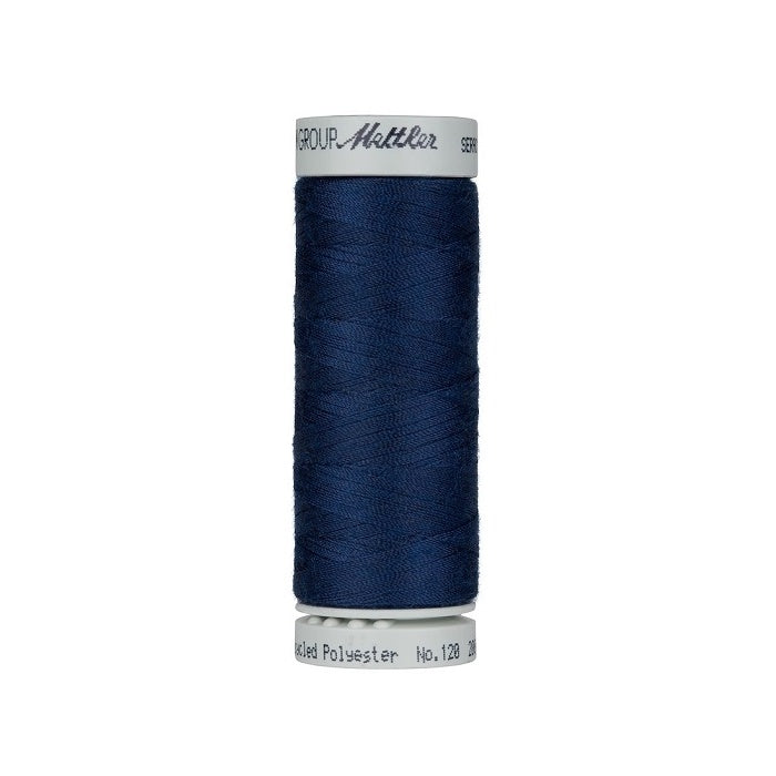 Spool of navy thread with Mettler Seracycle branding.