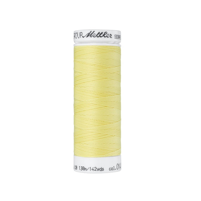 Spool of light yellow thread with Mettler Seraflex branding.