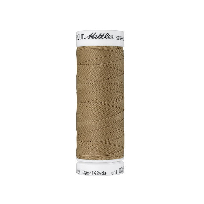Spool of tan brown thread with Mettler Seraflex branding.