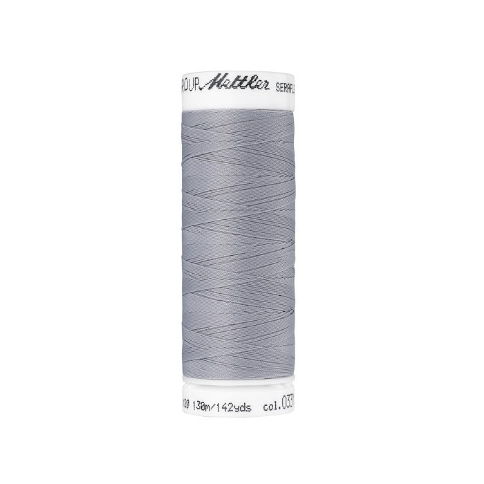 Spool of grey thread with Mettler Seraflex branding.