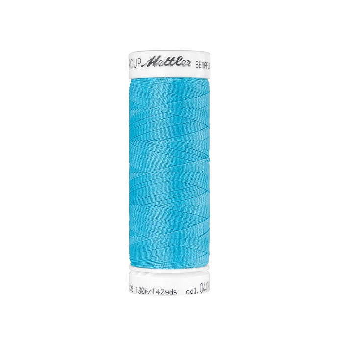 Spool of aqua blue thread with Mettler Seraflex branding.