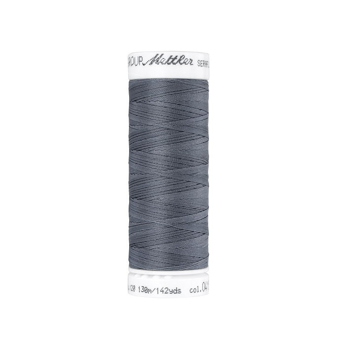 Spool of grey thread with Mettler Seraflex branding.